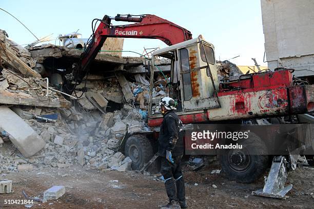 Rescue workers inspect the debris of a collapsed hospital, belongs to humanitarian aid organization "Doctors Without Borders" to save victims after...