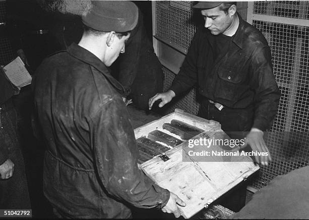 Workers Inspects Gold Bars Taken From Jews By The Nazi's And Stashed In The Heilbronn Salt Mines May 3, 1945 In Germany. The Treasures Were Uncovered...