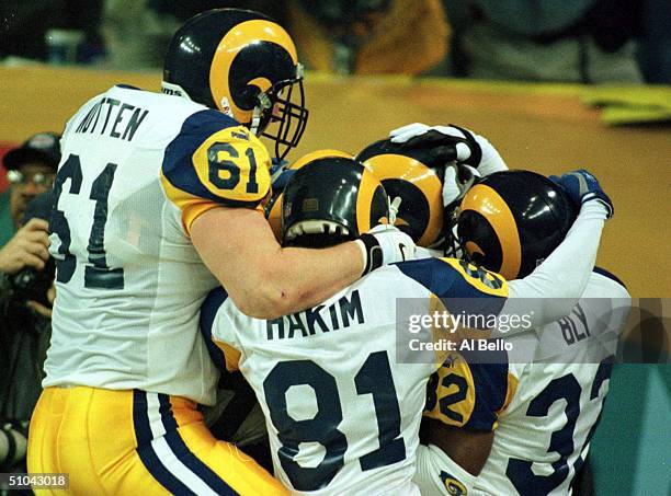 Tom Nutten, Az-Zahir Hakim And Dre Bly Of The St Louis Rams Celebrate With Isaac Bruce After His Game-Winning Touchdown In The Fourth Quarter Of...