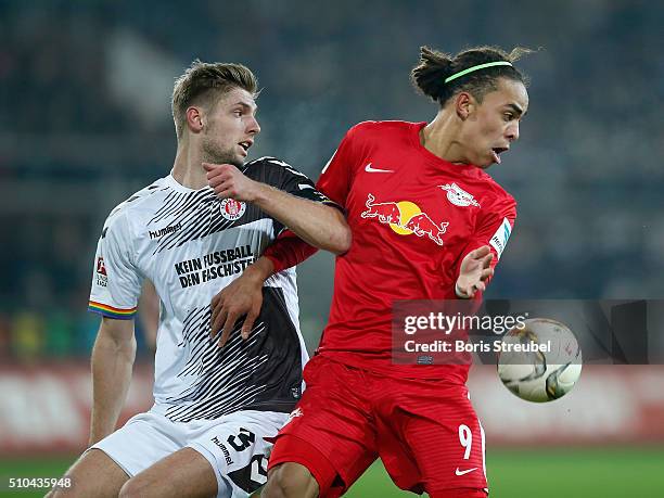 Lasse Sobiech of St. Pauli challenges Yussuf Poulsen of Leipzig during the Second Bundesliga match between FC St. Pauli and RB Leipzig at Millerntor...