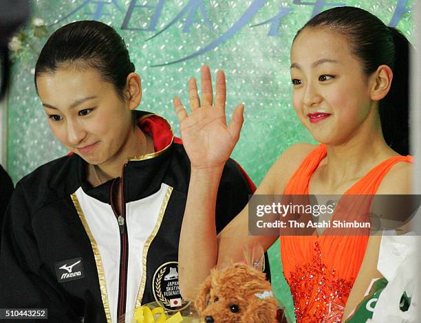 Mao Asada waits for her score after competing in the Women's Singles Short Program with her sister Mai Asada at the kiss and cry during day two of...