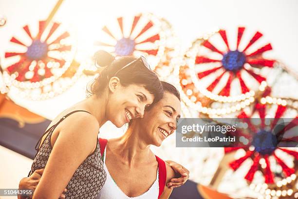 two friends at amusement park - luna park stock pictures, royalty-free photos & images