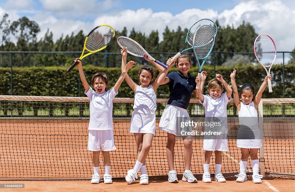 Happy kids playing tennis