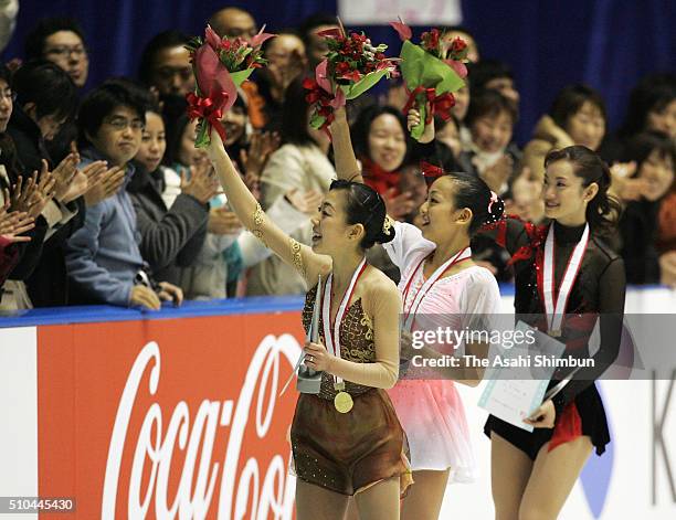 Gold medalist Fumie Suguri, silver medalist Mao Asada and bronze medalist Shizuka Arakawa applaud crowd after the medal ceremony for the Women's...
