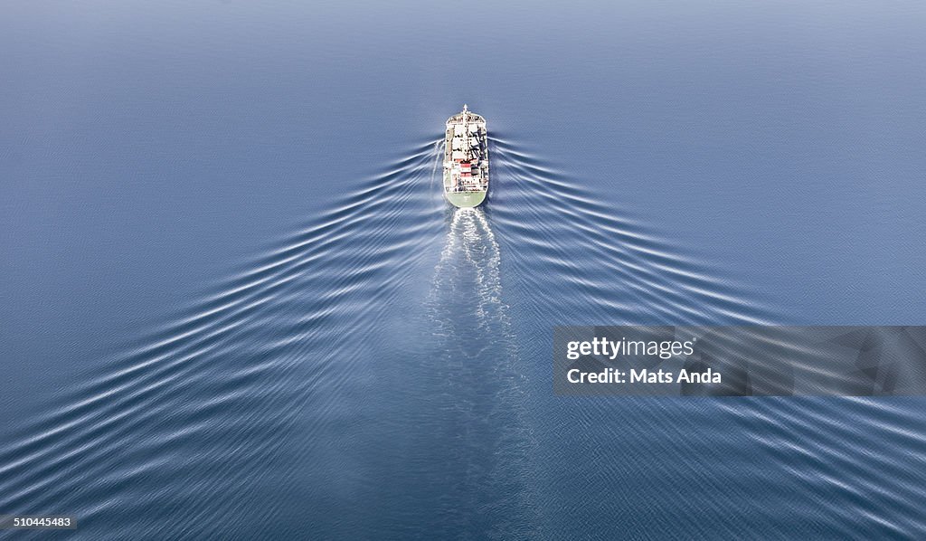 Vessel at sea with perfect symmetrical waves