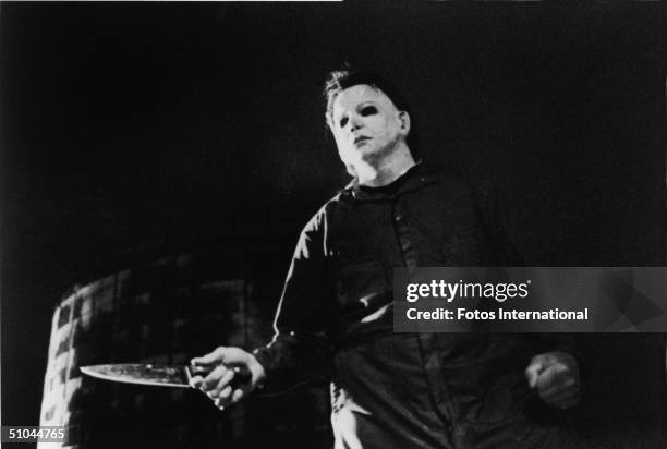 Actor Tony Moran, as masked kiler Michael Myers, wields a knife in a still from the horror film, 'Halloween,' directed by John Carpenter, 1978.