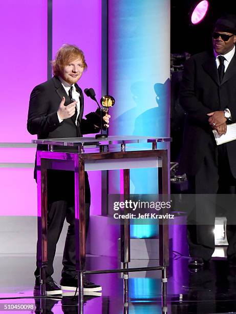 Recording artist Ed Sheeran accepts the award for Best Pop Solo Performance for 'Thinking Out Loud' alongside record producer Jimmy Jam onstage...