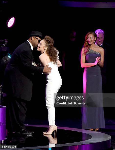 Singer Kendra Foster of The Vanguard accepts the award for Best R&B Song for 'Really Love' from record producer Jimmy Jam onstage during The 58th...