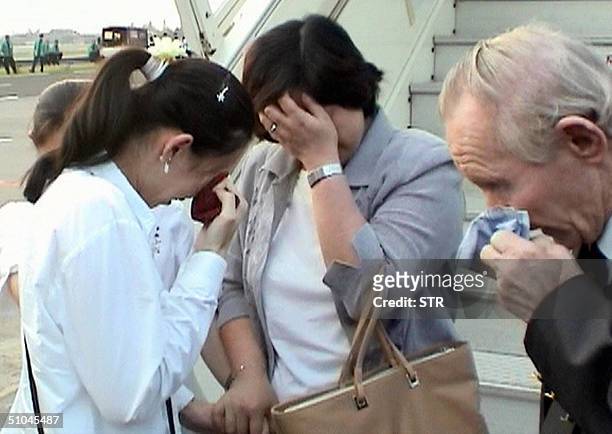 North Korean former abductee Hitomi Soga of Japan wipes away tears when her husband Charles Robert Jenkins and their daughter Mika and Belinda arrive...