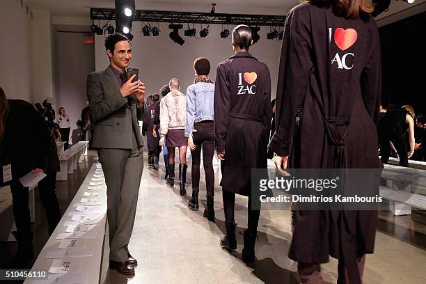 Designer Zac Posen prepares models on the runway at the Zac Posen Fall 2016 fashion show during New York Fashion Week at Spring Studios on February...