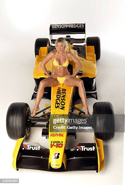 Model Nell McAndrew poses at a studio session with a Jordan F1 car ahead of this weekend's Formula One Grand Prix, held on July 8, 2004 at Holborn...