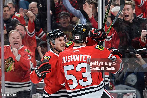 Dennis Rasmussen and Brandon Mashinter of the Chicago Blackhawks react after Mashinter scored against the Toronto Maple Leafs in the first period of...