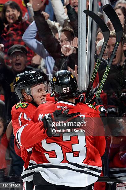 Dennis Rasmussen and Brandon Mashinter of the Chicago Blackhawks react after Mashinter scored against the Toronto Maple Leafs in the first period of...