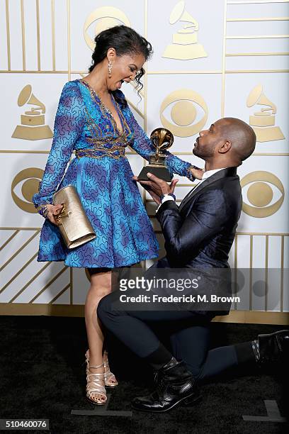 Songwriter Kirk Franklin holds his Best Gospel Performance/Song trophy for 'Wanna Be Happy?' with Tammy Collins pose in the press room during The...