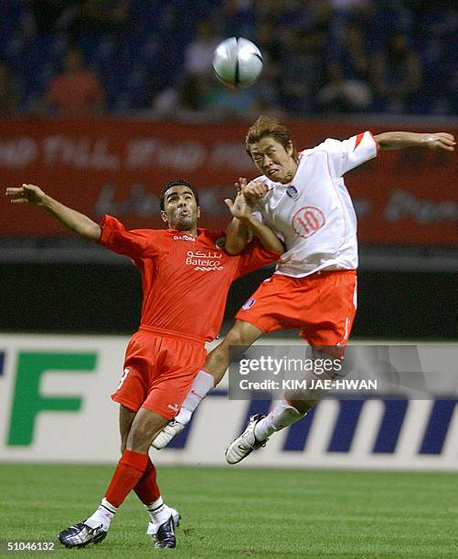 South Korea National team's player Hyun Young-Min heads the ball with Bahrain's player Rashid Al Dossary during their friendly match in Gwangju in...