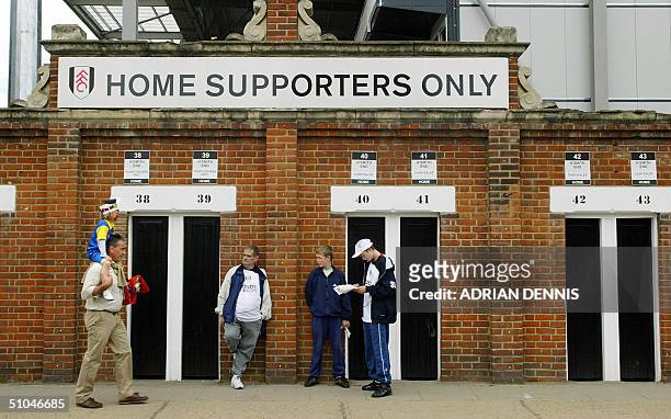 Fulham football club supporters wait outside the turnstiles before the pre-season friendly match against Watford at Craven Cottage in London 10 July...