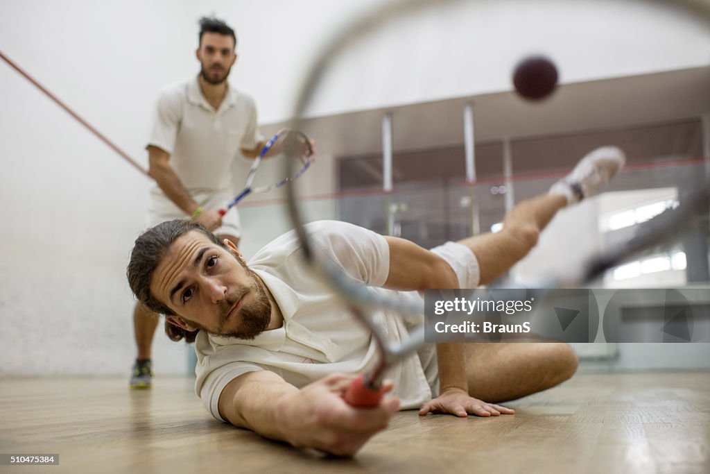 Reaching for the squash ball!
