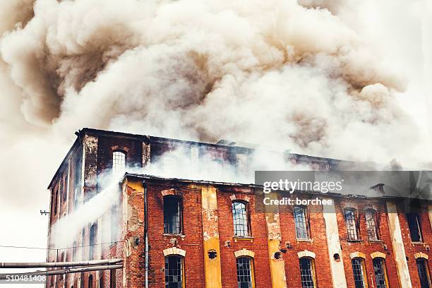 fire in an old building - factory building exterior stock pictures, royalty-free photos & images