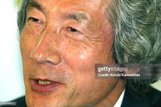 Japanese Prime Minister Junichiro Koizumi listens to the results of the Upper House elections at the headquarters of his ruling Liberal Democratic...