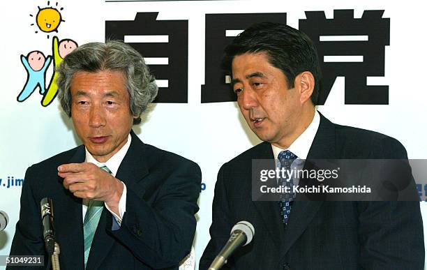 Japanese Prime Minister Junichiro Koizumi and Shinzo Abe , secretary-general of the ruling Liberal Democratic Party watch reports from the Upper...