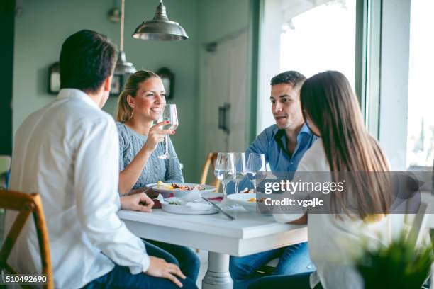 friends enjoying lunch in restaurant. - double date stock pictures, royalty-free photos & images