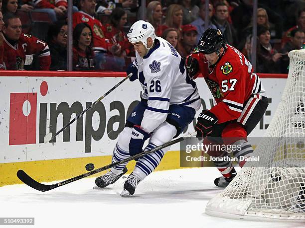 Daniel Winnik of the Toronto Maple Leafs battles for the puck with Trevor van Riemsdyk of the Chicago Blackhawks at the United Center on February 15,...