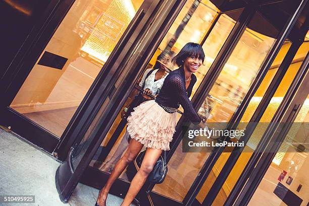 woman leaving the hotel - revolving door stock pictures, royalty-free photos & images