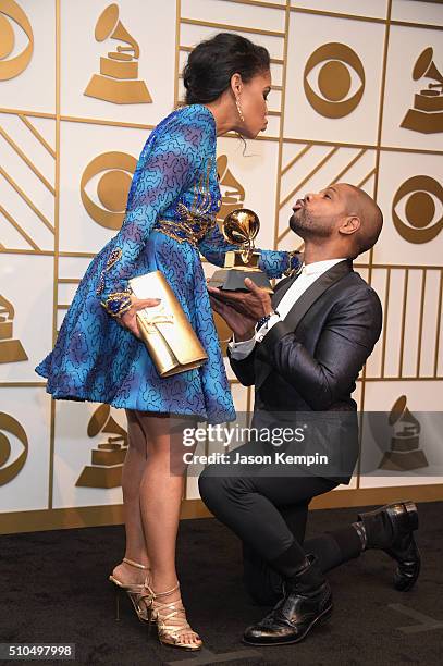 Songwriter Kirk Franklin holds his Best Gospel Performance/Song trophy for 'Wanna Be Happy?' with Tammy Collins poses in the press room during The...