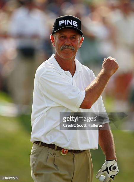 Mark James of England pumps his fist on the 18th green after winning the Ford Senior Players Championship at the TPC of Michigan on July 11, 2004 in...