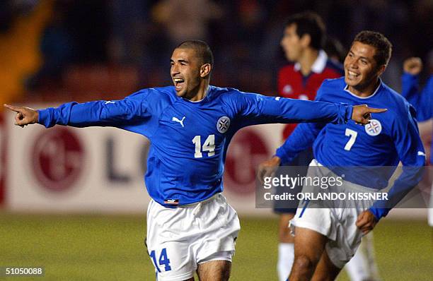 Paraguayan soccer player Ernesto Cristaldo celebrates his goal followed by his teammate Dante Lopez 11 July 2004, at the UNSA stadium during a Copa...