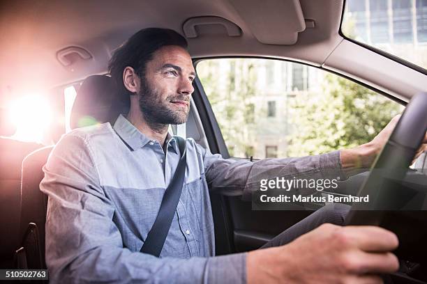 businessman driving his car - guidare foto e immagini stock