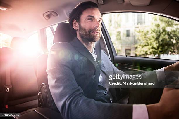 businessman driving his car - driving sun stock pictures, royalty-free photos & images