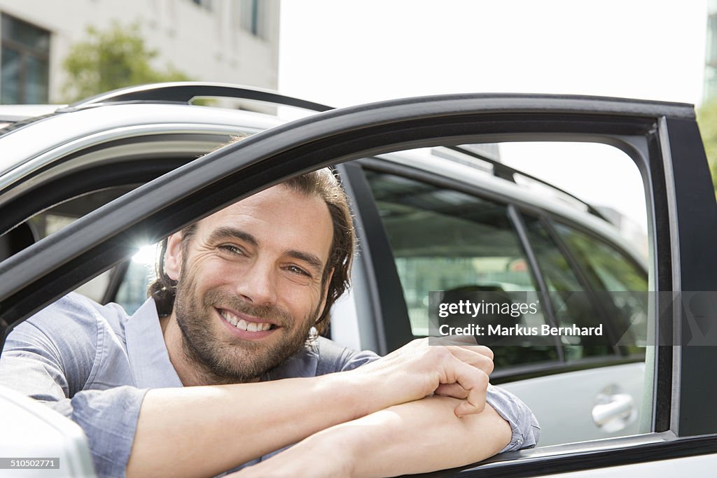 Man leaning out of his car window