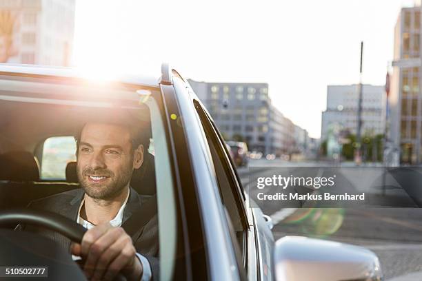 businessman driving car in the city. - business person driving stockfoto's en -beelden