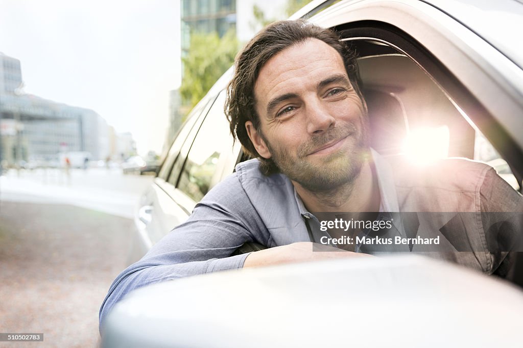 Man leaning out of his car window