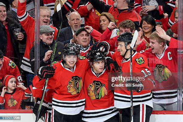 Patrick Kane of the Chicago Blackhawks celebrates with Artemi Panarin and Artem Anisimov after scoring in the third period of the NHL game against...