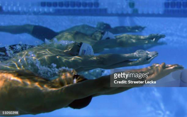 Michael Phelps swims underwater at the start of the 200 meter backstroke semifinal during the US Swimming Olympic Team Trials on July 11, 2004 at the...
