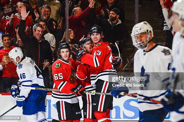 Viktor Svedberg of the Chicago Blackhawks celebrates with Jonathan Toews and Andrew Shaw after scoring in the third period of the NHL game against...