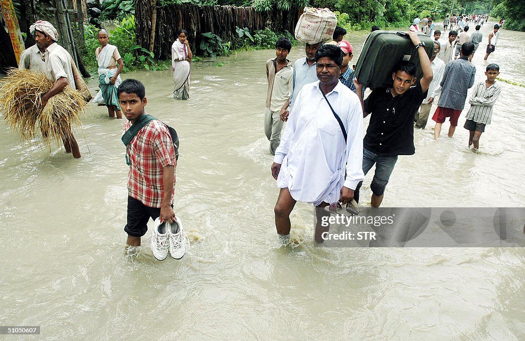 Indian vllagers carry their possessions