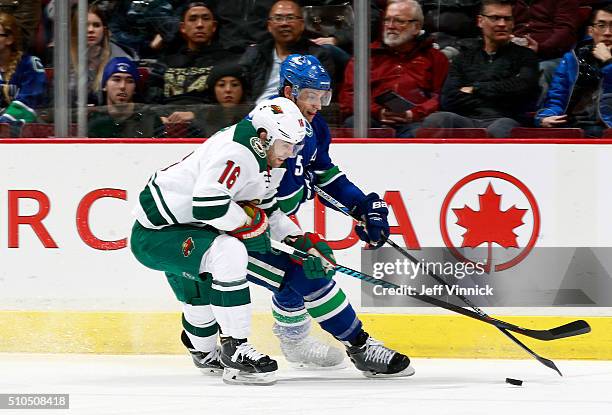 Jason Zucker of the Minnesota Wild and Luca Sbisa of the Vancouver Canucks battle for the puck during their NHL game at Rogers Arena February 15,...