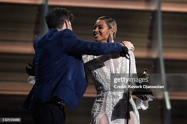 Producer Mark Ronson accept the Record Of The Year award for 'Uptown Funk' from Recording artist Beyonce onstage during The 58th GRAMMY Awards at...