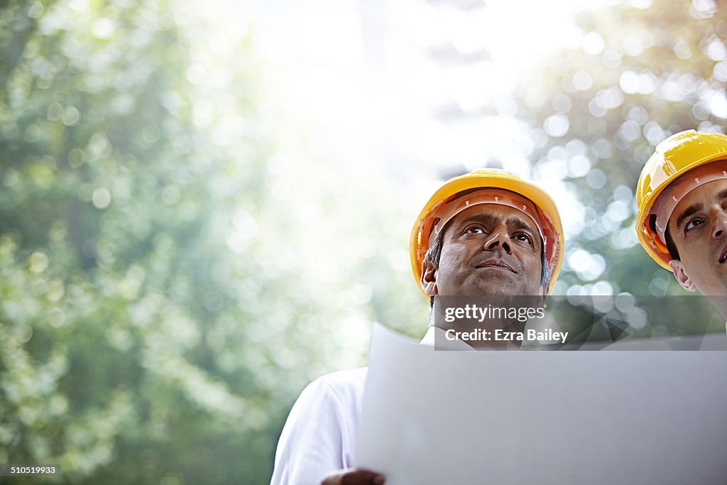 Two architects discussing a plan in the city.