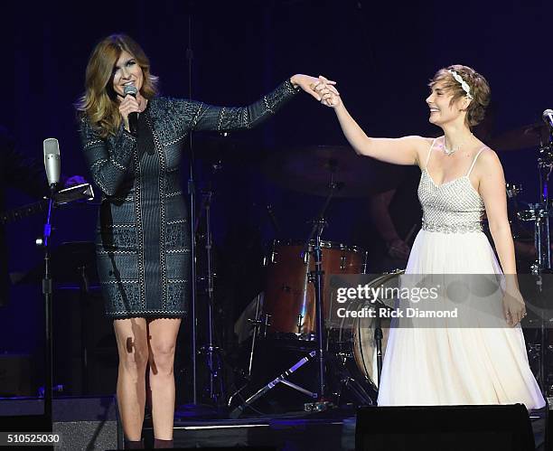 Host Connie Britton and Clare Bowen perform during "Nashville for Africa" a benefit for the African Children's Choir at the Ryman Auditorium on...