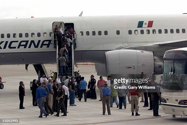 Group of 130 Mexican nationals who entered the U.S illegally are shown boarding a special Mexicana Aviation charter flight to Mexico City, the first...