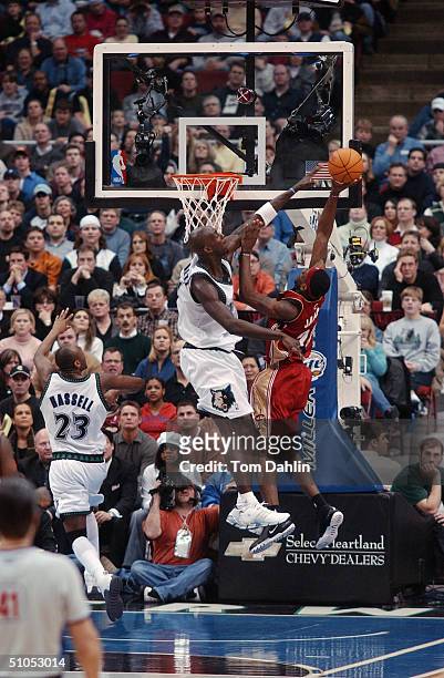 LeBron James of the Cleveland Cavaliers puts up a shot against Kevin Garnett of the Minnesota Timberwolves during the game at Target Center on...