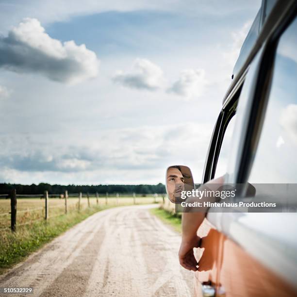 man in mirror of a bus on country road - 2014 track field stock pictures, royalty-free photos & images