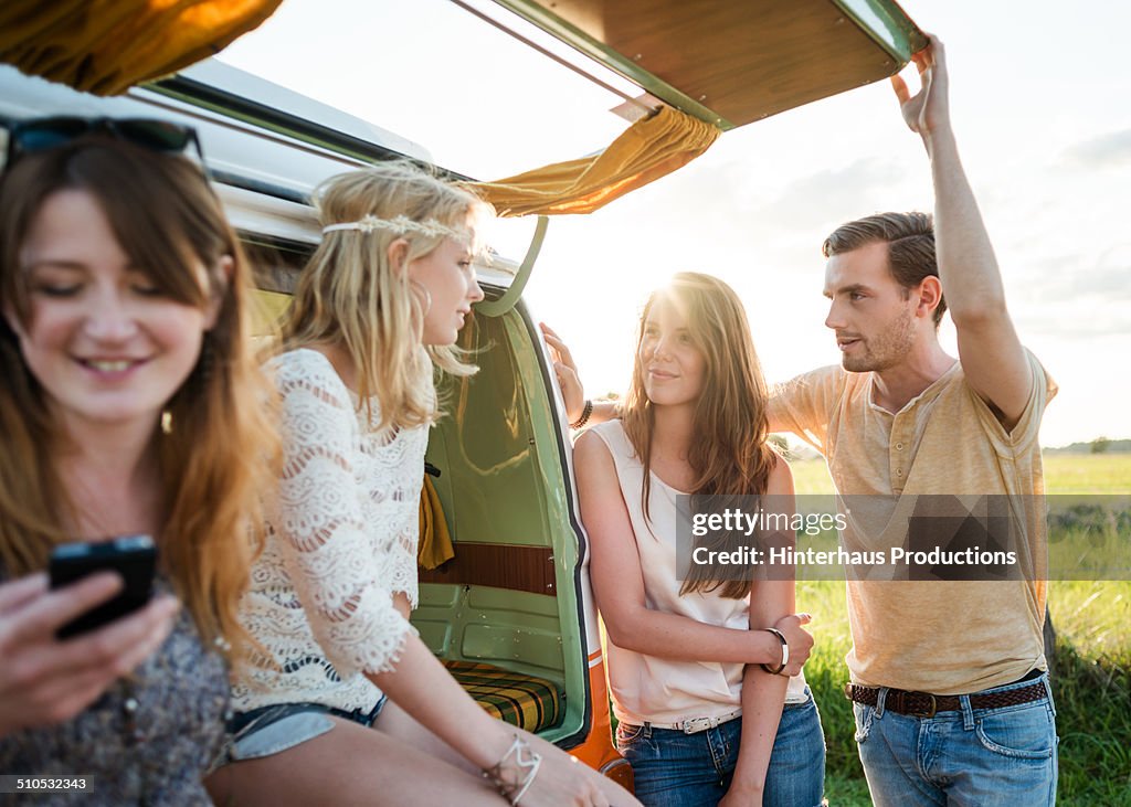 Young People Chatting Backside Of A Camping Bus