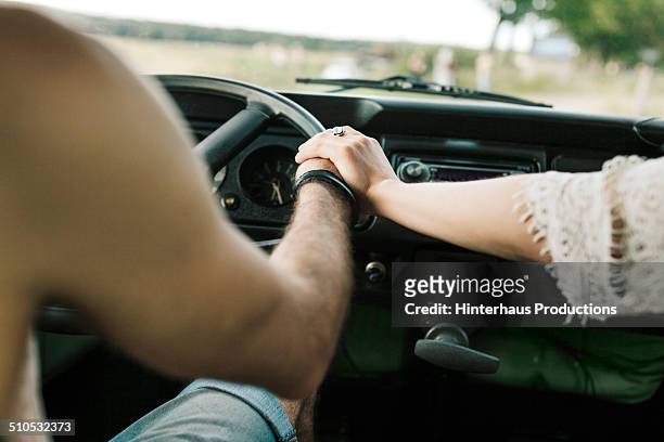 holding hands - holding hands in car stock pictures, royalty-free photos & images