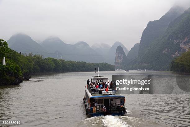 cruise boat on lijiang river, guangxi region china - li river stock pictures, royalty-free photos & images