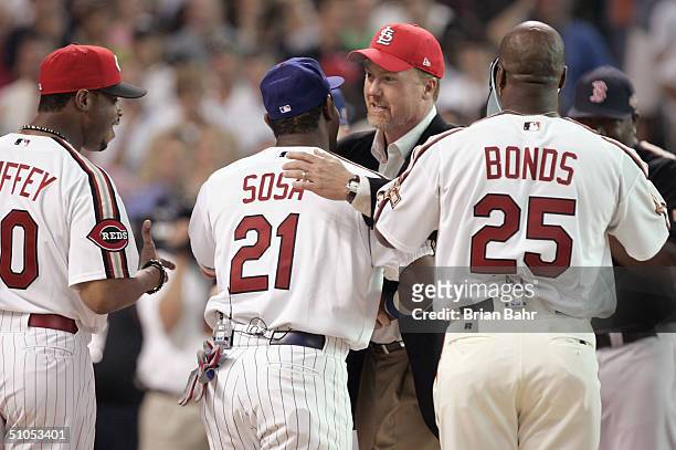 Mark McGwire shakes hands with Sammy Sosa of the National League team as Barry Bonds and Ken Griffey Jr. Look during a ceremony homoring members of...